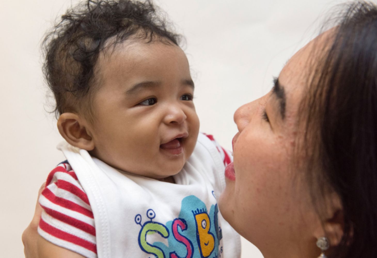 Baby smiling at woman